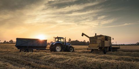 Traktor v západu slunce během sklizně.