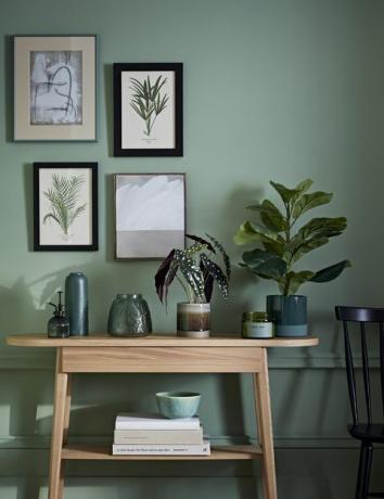 stylový pokoj se zelenou barvou a dřevěným příborníkem